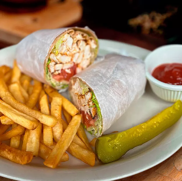 Burrito stuffed with meat, French fries and tomato sauce